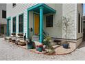 A charming front porch with colorful accents, decorative planters, and a vibrant yellow front door at 3 1/2 Maranda Holmes St # B, Charleston, SC 29403
