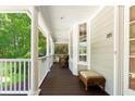 Spacious porch with wicker furniture, white columns, and view of the manicured lawn, perfect for outdoor relaxation at 3171 Pignatelli Cres, Mount Pleasant, SC 29466