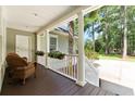 Inviting porch with comfortable seating, white columns, and hanging flower baskets, offering a relaxing outdoor space at 3171 Pignatelli Cres, Mount Pleasant, SC 29466