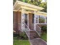 Close-up of a decorative brick front porch with white metal supports and steps leading to the front door at 344 Canterbury Rd, Charleston, SC 29407