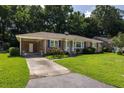 Classic brick home featuring a covered carport and inviting front yard, exuding curb appeal at 344 Canterbury Rd, Charleston, SC 29407