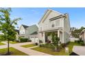 Charming two-story home featuring a welcoming front porch and landscaped front yard at 347 Ripple Park Dr, Summerville, SC 29486