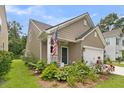 Charming home with manicured lawn, flower beds, and a rocking chair on the covered front porch at 3789 Tupelo Branch Row, Mount Pleasant, SC 29429