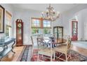 Charming dining room with an elegant chandelier, a rug and a grandfather clock at 391 Evian Way, Mount Pleasant, SC 29464