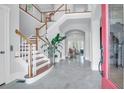 Grand foyer featuring hardwood stairs, a large plant, and an open floor plan at 391 Evian Way, Mount Pleasant, SC 29464