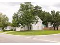 Residential street view of a two-story home with a well-kept lawn and mature trees at 407 Thomaston Ave, Summerville, SC 29485