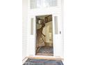 Inviting foyer with wood staircase, decorative rug, and bright natural light streaming through the front door at 407 Thomaston Ave, Summerville, SC 29485