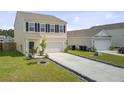 Well-kept two-story home featuring a long driveway, manicured lawn, and traditional design elements at 494 Pender Woods Dr, Summerville, SC 29486