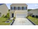 Charming two-story home with a large driveway, black shutters, and well-maintained landscaping at 494 Pender Woods Dr, Summerville, SC 29486
