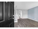 The living room boasts stylish wood-look tile flooring, modern paint and trim, and a staircase at 507 Stinson Dr # 4G, Charleston, SC 29407