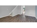 The living room boasts stylish wood-look tile flooring, modern paint and trim, and a staircase at 507 Stinson Dr # 4G, Charleston, SC 29407