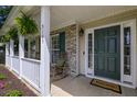 Inviting front porch with rocking chairs, hanging ferns, and a 'Welcome' mat for a warm, friendly entry at 5105 Parrum Ct, Summerville, SC 29485