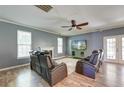 Spacious living room with fireplace, ceiling fan, and a view of the outdoor landscape from French doors at 5105 Parrum Ct, Summerville, SC 29485