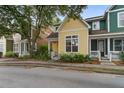 Charming two-story home with yellow siding, white trim, inviting porch, and well-maintained lawn at 5134 E Liberty Park Cir, North Charleston, SC 29405