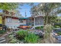Spacious backyard featuring a pond, a fire pit, a screened porch, and a hot tub for outdoor living at 520 E Huron Ave, Folly Beach, SC 29439