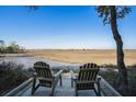 Tranquil marsh view with seating, showcasing the natural beauty of the surrounding landscape at 520 E Huron Ave, Folly Beach, SC 29439