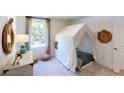 Neutral bedroom with a fun tent, round mirror, and white dresser, creating a playful space at 529 Blue Mistflower Dr, Moncks Corner, SC 29461