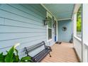Inviting front porch with a bench, decorative lanterns, and a charming welcome mat at 542 Amalie Farms Dr, Charleston, SC 29492