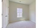 Bright, empty bedroom with carpet, a window, and a closet, ready for personalization at 549 Blue Mistflower Dr, Moncks Corner, SC 29461