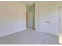 Neutral bedroom with carpet, closet with double doors, and doorway to another room at 549 Blue Mistflower Dr, Moncks Corner, SC 29461