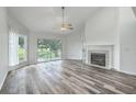 Bright living room with a vaulted ceiling, fireplace, and scenic outdoor views at 638 Harbor Creek Pl # 19, Charleston, SC 29412