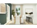 Bright dining area featuring a wooden table, elegant white chairs, and contemporary artwork at 639 Culpepper St, Summerville, SC 29486