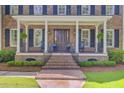 Inviting front porch with brick stairs, columns, and a dark wood front door at 750 Navigators Run, Mount Pleasant, SC 29464