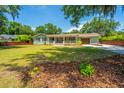 Inviting home with mature trees, a well-kept lawn, and a charming front porch at 762 Swanson Ave Ave, Charleston, SC 29412