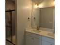Modern bathroom featuring double sinks, white cabinets, and a glass shower at 7763 Park Gate Dr, North Charleston, SC 29418