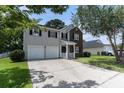 Charming two-story home with a two-car garage and a well-manicured front yard at 8044 Old London Rd, North Charleston, SC 29406