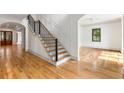 Inviting foyer with staircase, hardwood floors, and an archway to the right at 8187 Jack Island Dr, Johns Island, SC 29455