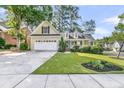 Beautiful home with a two-car garage, inviting front porch, and manicured landscaping at 8618 Woodland Walk, North Charleston, SC 29420