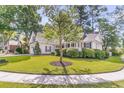 Well-maintained home with mature trees, lush lawn, and classic architecture at 8618 Woodland Walk, North Charleston, SC 29420