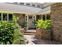 Inviting front entrance with brick steps and planters, leading to a well-maintained brick facade at 914 Red Coat Run, Mount Pleasant, SC 29464