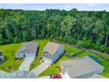 Aerial view of homes with green yards and mature trees creating a private setting at 9808 Wooden Pestle Way, Ladson, SC 29456