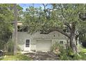 Two-story home with a driveway and mature landscaping at 1014 E Cooper Ave, Folly Beach, SC 29439