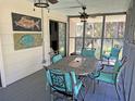 Cozy screened porch with dining table and chairs at 1014 E Cooper Ave, Folly Beach, SC 29439