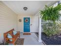 Cozy front porch with a wooden bench, potted plants, decorative wreath on a blue door at 105 Lovette Ct, Goose Creek, SC 29445