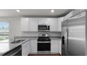 Bright kitchen featuring white cabinets, stainless steel appliances, and granite countertops at 143 Haventree Ct, Summerville, SC 29486