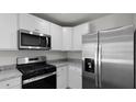 Modern kitchen featuring white cabinets, stainless steel appliances, and granite countertops at 143 Haventree Ct, Summerville, SC 29486