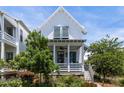 Charming two-story white home boasting a welcoming porch and fresh landscaping at 1466 Mizzen Aly, Johns Island, SC 29455