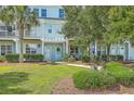 Charming two-story condo with light-blue siding, manicured bushes, and a welcoming front entrance at 1723 Brittlebush Ln, Johns Island, SC 29455