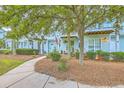Charming two-story condo with light-blue siding, manicured bushes, and a welcoming front entrance at 1723 Brittlebush Ln, Johns Island, SC 29455