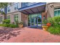 Inviting brick entrance showcasing glass doors, lush plants, and a paved walkway at 200 River Landing Dr # 307B, Charleston, SC 29492