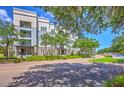 Beautiful condo exterior view highlighting manicured lawns, mature trees, and inviting community atmosphere at 200 River Landing Dr # 307B, Charleston, SC 29492