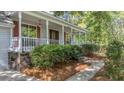 Charming home's front porch and lush landscaping create an inviting entry at 202 Woodbridge Dr, Summerville, SC 29486