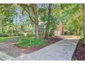 View of home with brick exterior, showing garage, driveway, and landscaped yard at 303 High Grove Rd, Summerville, SC 29485
