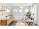 Stylish office featuring a decorative light fixture, large windows, and elegant decor, perfect for a productive workspace at 306 Archar St, Summerville, SC 29486
