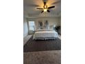 Relaxing main bedroom with a large bed, soft neutral tones, tray ceiling, and stylish decor at 316 Beachgrass Ln, Summerville, SC 29486