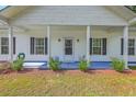 Inviting front porch showcases detailed trim, a welcoming front door, and tasteful landscaping at 326 Turner Ln, Round O, SC 29474